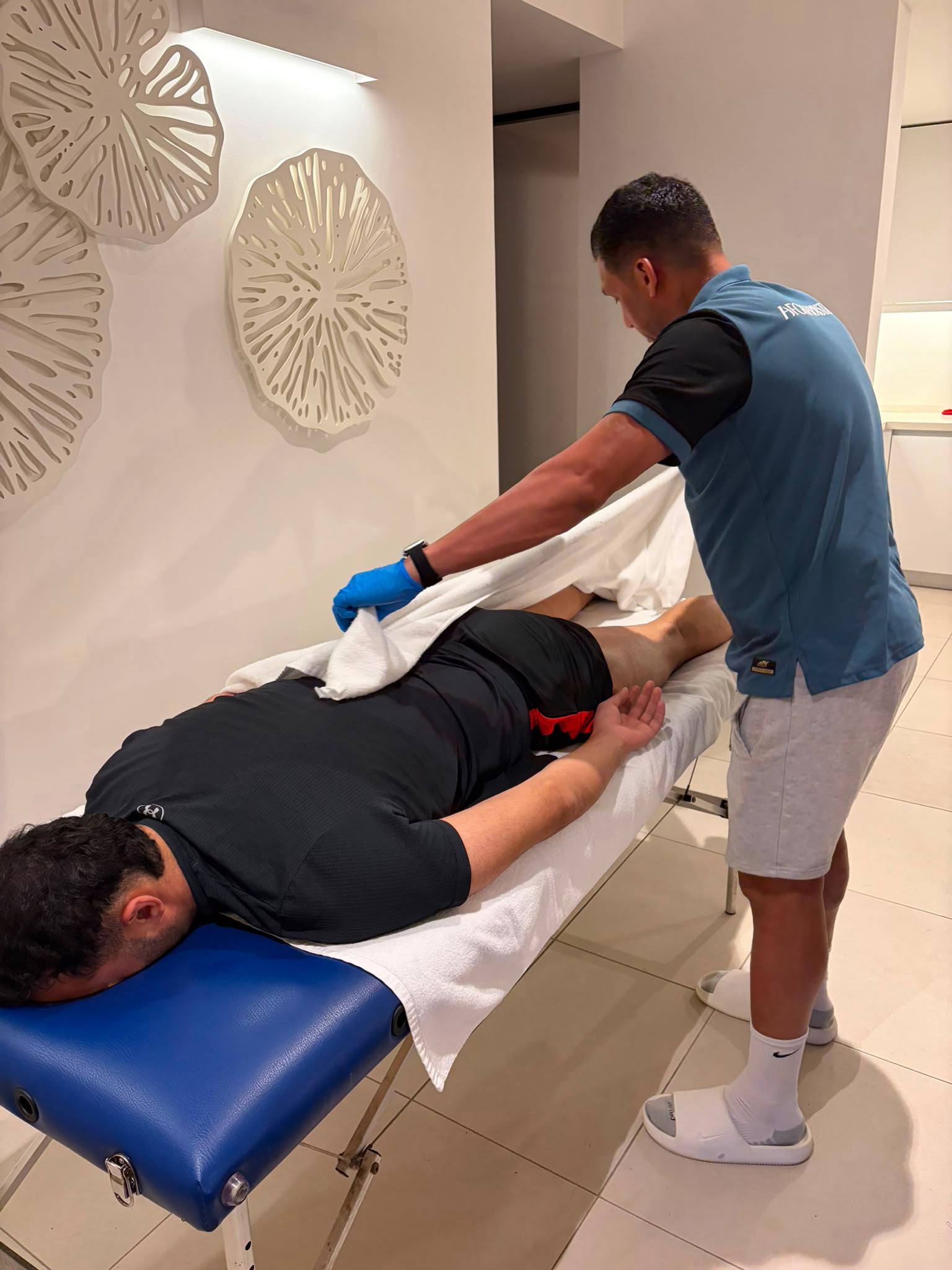 Over-the-shoulder view of towel-draped hands-on treatment